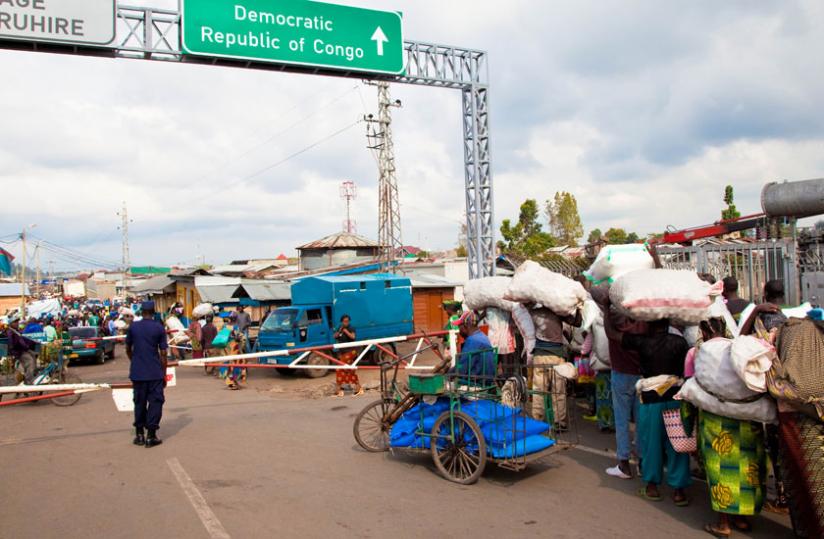 Traders carry merchandise across the Rwanda-Congo border enroute to Goma. (Timothy Kisambira)