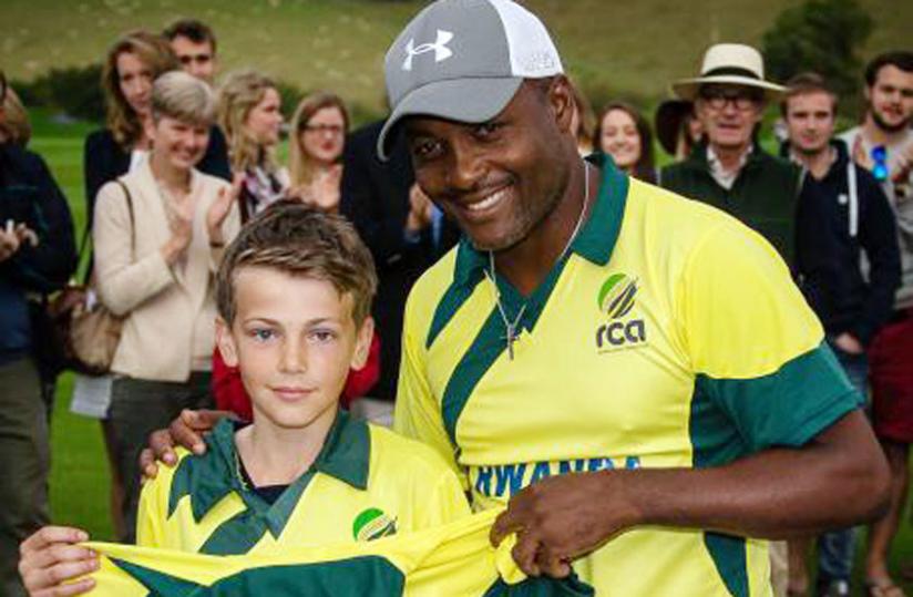 Brian Lara (left) with cricket fan Dee Jarvis at the end of the charity match played on Monday. (Courtesy photo)