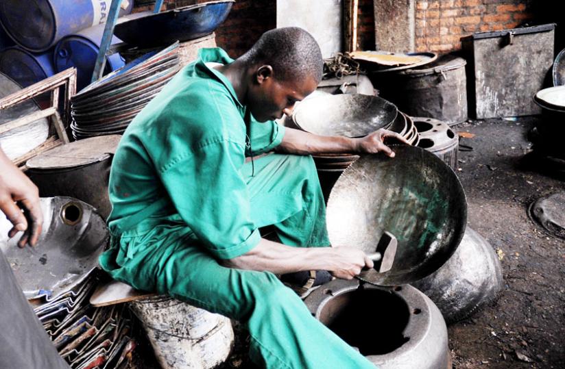 A youth fabricates metal pans in Gakinjiro, Kigali. Start-up incubation expert Lavelle says government is too generous in its endorsement of start-ups. (John Mbanda)