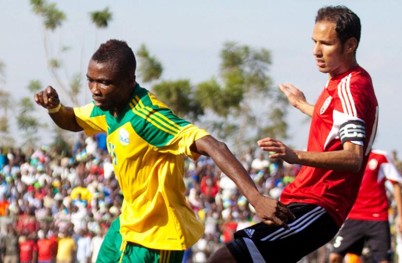 Dady Birori beats Libya captain to the ball during the first round return leg qualifiers at Kigali Regional Stadium in which he scored a hat-trick. (T. Kisambira)
