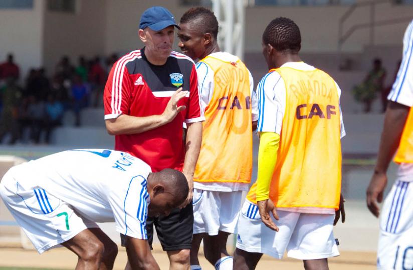 Talking tactics: Amavubi coach Stephen Constantine with his players during a training session. (T. Kisambira)