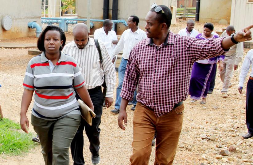 State Minister for Water and Energy Germaine Kamayirese (L) is taken around Nzove Water Treatment Plant in Kimisagara by Water and Sanitation Corporation managing director James Sano on Wednesday. (John Mbanda)