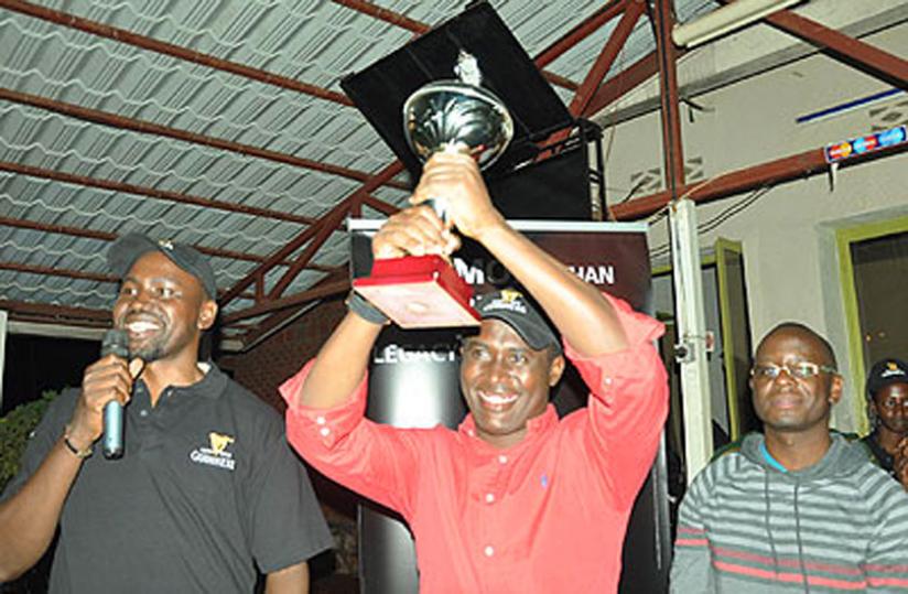 Kigali Golf club president Dr. Richard Gakuba recieves the trophy in February. (File photo)