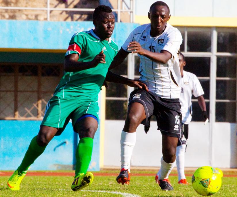 Kiyovuu00e2u20acu2122s Uganda-born striker Julius Bakabulindi, left, battles with APRu00e2u20acu2122s midfielder Andrew Buteera during a first round league match. (Timothy Kisambira)