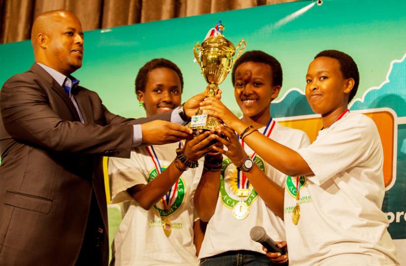 Gasana presents the award to Gashora girls; Ituze Stella, Bwiza Belise, and Uwase Angela.(Timothy Kisambira) rn