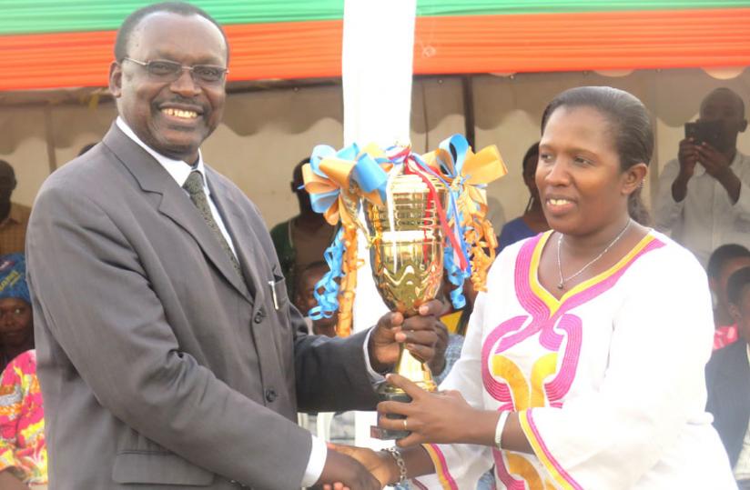Kanimba hands a trophy to Uwamariya in Rwamagana on Monday. (Stephen Rwembeho) 