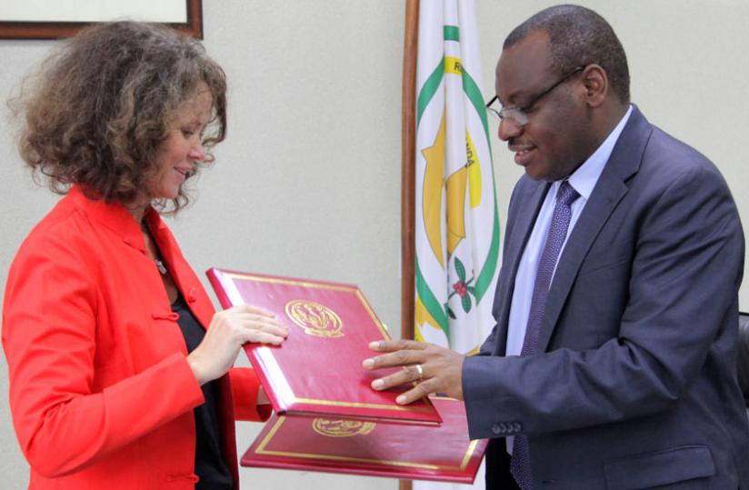 Turk (L) and Gatete exchange documents during the signing ceremony in Kigali yesterday. (John Mbanda)