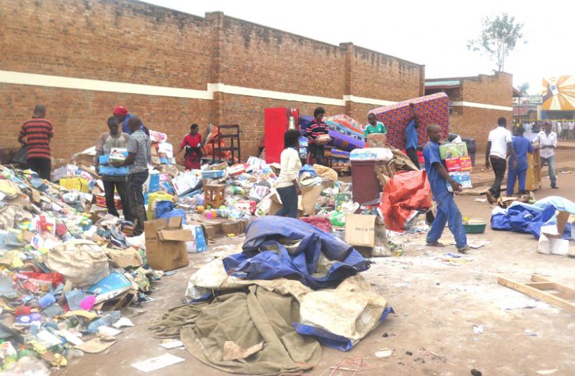 Traders try to rescue some of their items. (Stephen Rwembeho)