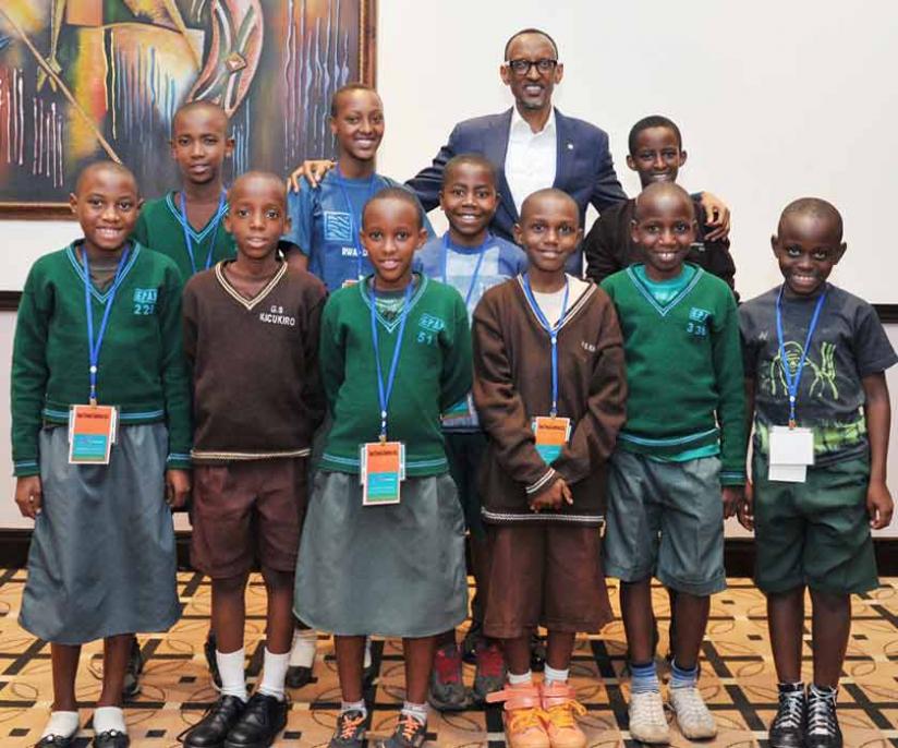 President Kagame poses with some of the primary school children who use One Laptop Per Child gadgets. rn(Village Urugwiro). 