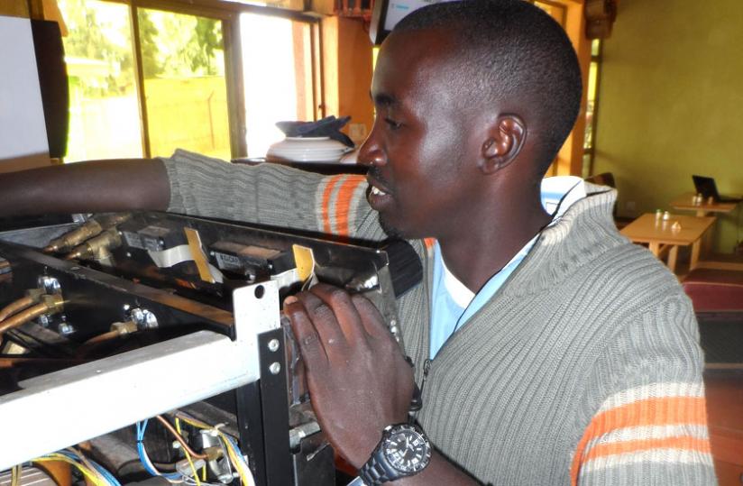 Maniraguha fixing a machine. (Moses Opobo)