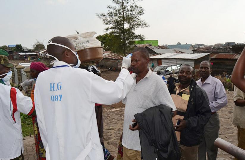 A Rwandan medical official screens travellers crossing into Rwanda from DR Congo for Ebola. The country is on high alert as Marburg, an Ebola-like disease is confirmed in Uganda. (File)
