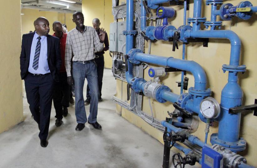 Rwanda Energy Group CEO Jean Bosco Mugiraneza (left) on a guided tour of the Nyabarongo hydro project in Muhanga District last week.