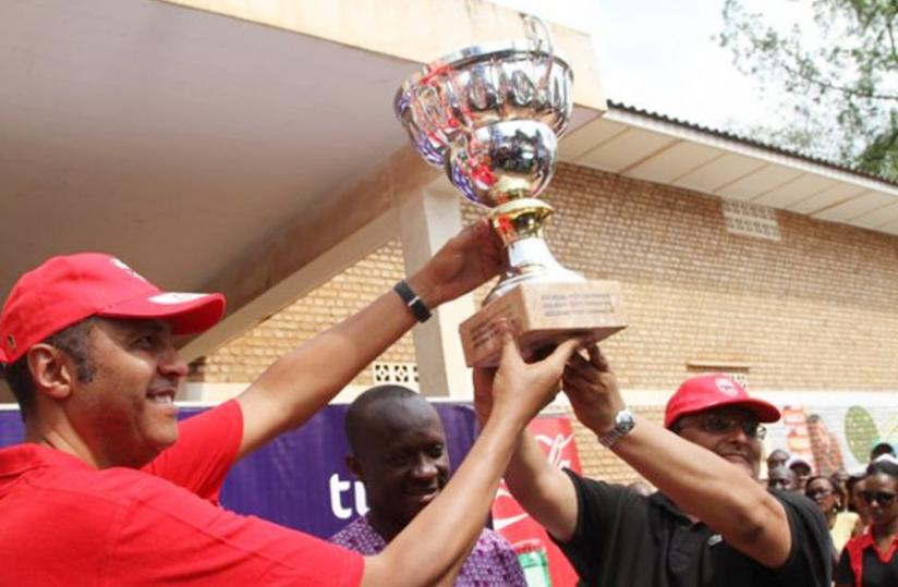 Bukera Valerie and Ketia Nithal celebrate after winning the Huye Rally. In the background is Minister for Sports and Culture, Joseph Habineza. (Courtesy)