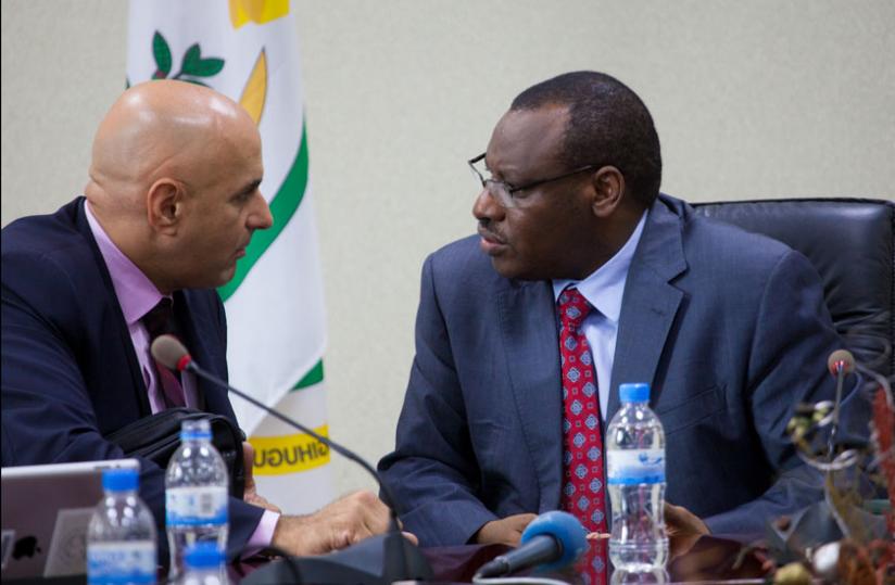  Drummond (L) chats with Amb.  Gatete at the media briefing in Kigali yesterday.(Timothy Kisambira)