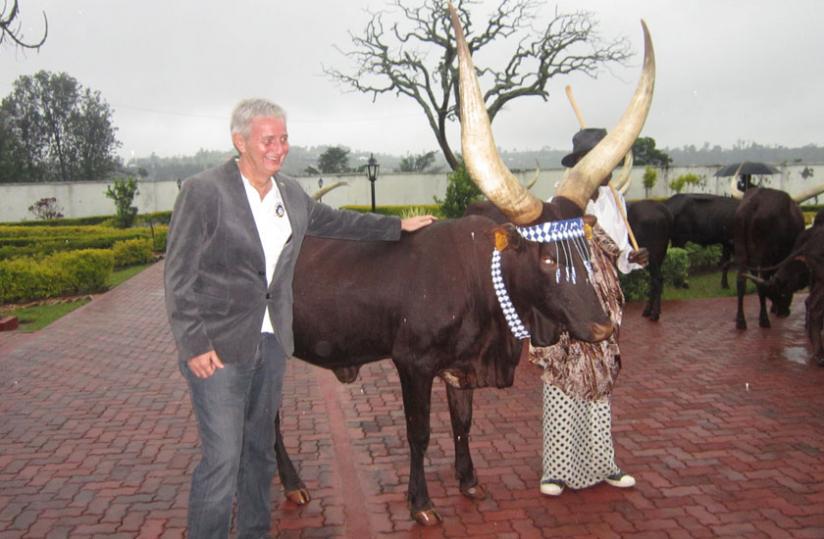 A tourist poses for a photo with Inyambo cow recently. (File)