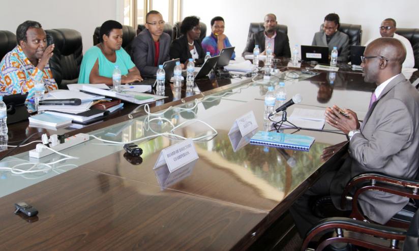 PAC chairperson Juvenal Nkusi (L) puts Rutayisire (R) to task over studentsu00e2u20acu2122 loans yesterday. (John Mbanda)