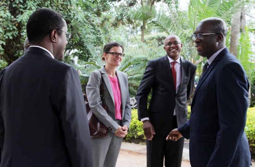 Murekezi (right) chats with Natural Resources minister Dr Vincent Biruta (left) and other officials moments before the launch of Fonerwa in Kigali on Thursday. (John Mbanda)