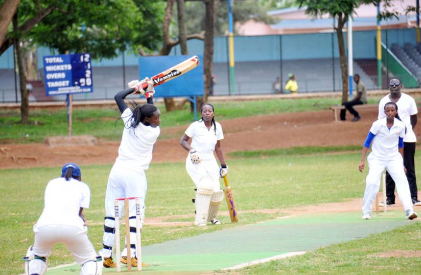 Queens of Victory captain Jeanne d'Arc Sibo (L) takes a shot off the bowling of Betty Mukunzi (R) of White Clouds CC. (Pontian Kabeera)