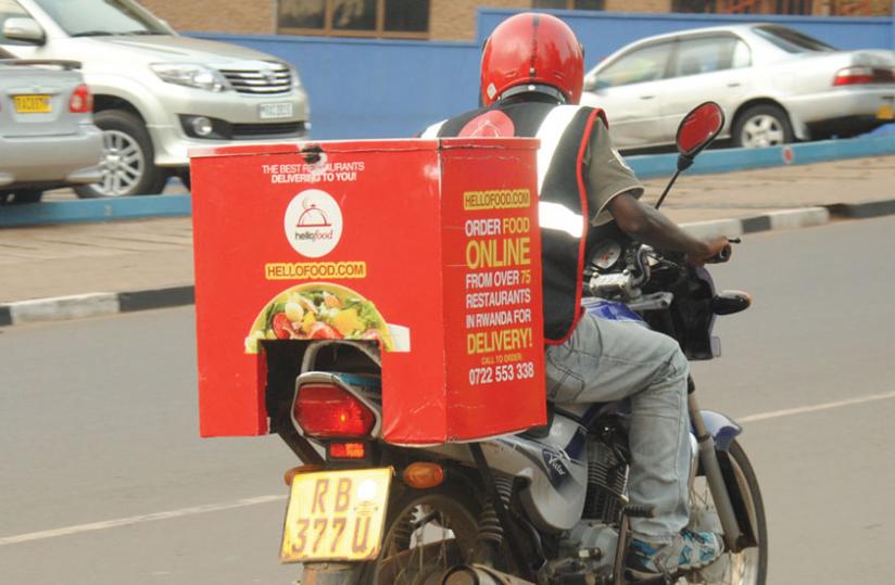 A delivery man takes food to clients in a Kigali suburb recently. 