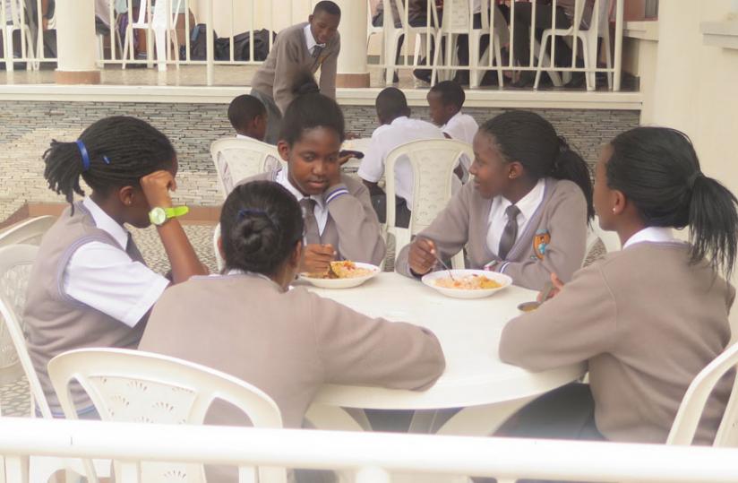 Students having lunch. Some skip meals when members of the opposite sex are around. (Solomon Asaba)