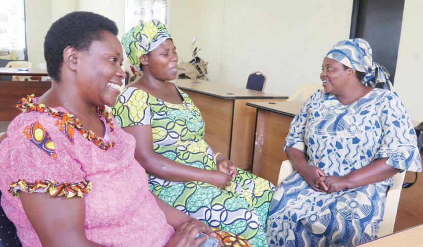 Members of the Abuzi commiitte of Kibaza cell share a light moment. (Doreen Umutesi)