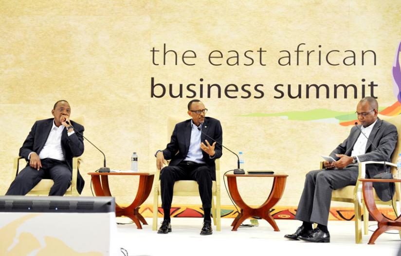 President Kagame addresses the East African Business Summit alongside Kenyan President Uhuru Kenyatta in a panel discussion moderated by Joshua Oigara, the chief executive of Kenya Commercial Bank (R), in Kigali yesterday. (Village Urugwiro)