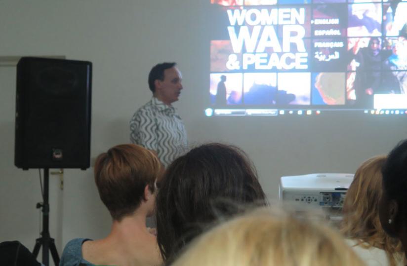 A moderator explains to the guests the documentaries that would be screened.  (Arnold Agaba)