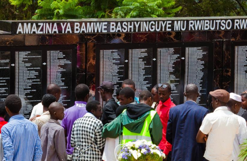 Mourners check the names of Genocide victims buried at Rebero memorial in Kigali during a commemorative event last April. (File)