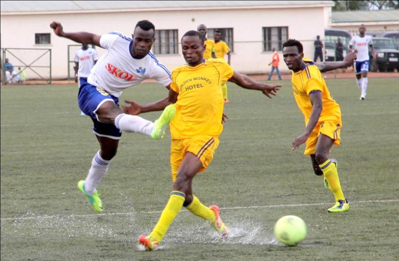 Goal scorer Peter Otema (L) attempts to go past Amagaju defender Joachim Alanga in the opening game of the season yesterday at Stade de Kigali. (John Mbanda)