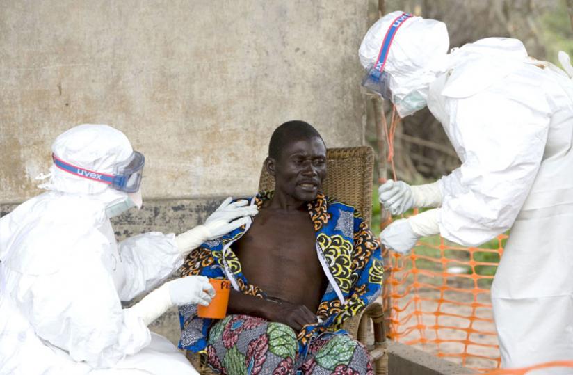 Health workers attend to a suspected Ebola victim in West Africa. The disease is ravaging economies across the continent. (Internet photo)