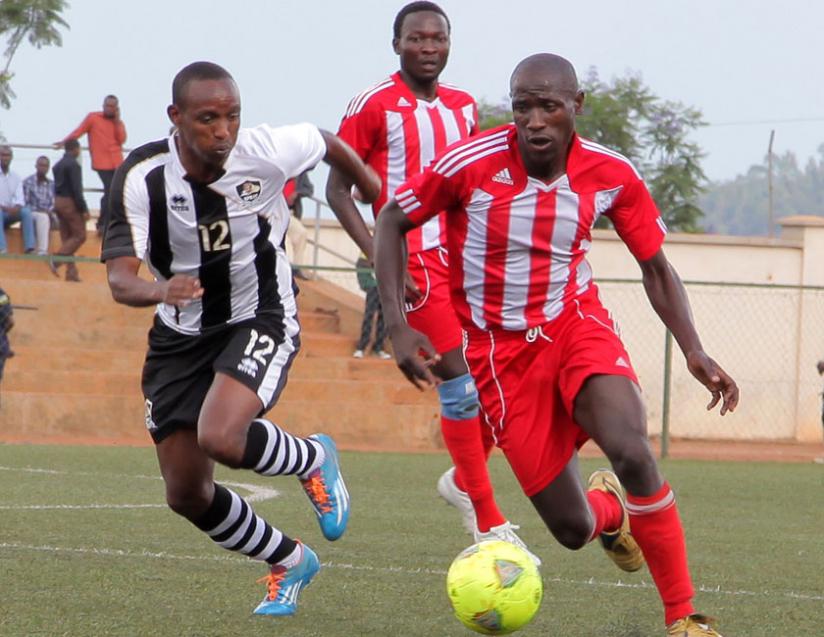 APRu00e2u20acu2122s Jean Claude Iranzi (L) tracks back after losing the ball to Musanze midfielder Japhet Hakizimana in yesterdayu00e2u20acu2122s league match. (John Mbanda)