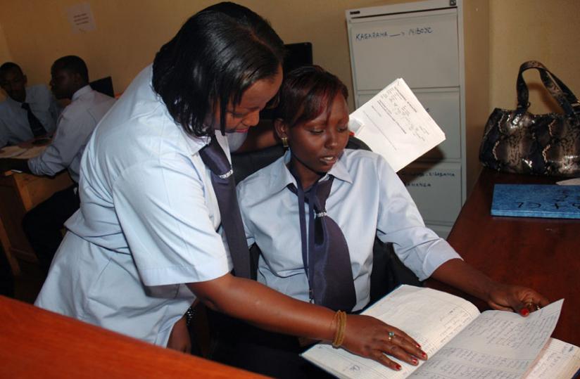 An employee consults a colleague on a work-related issue. Sharing knowledge empowers people and improves communities. (File)