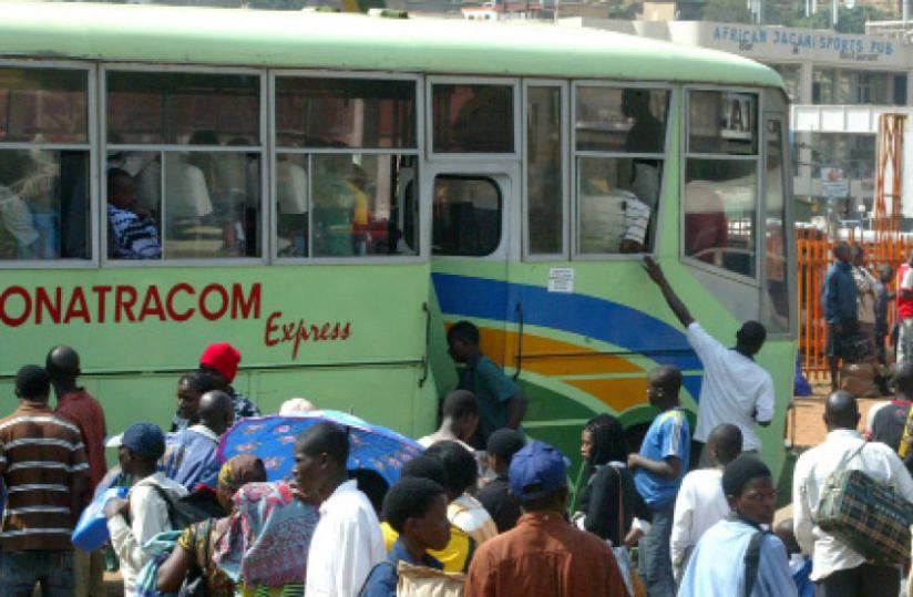 Passengers struggle to get on an Onatracom bus in Nyabugogo park. (File)