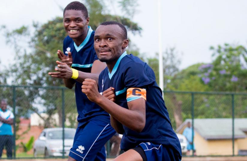 Police captain Jacques Tuyisenge and striker Emmanuel Sebanani celebrate one of the five goals that Police scored yesterday. (Timothy Kisambira)