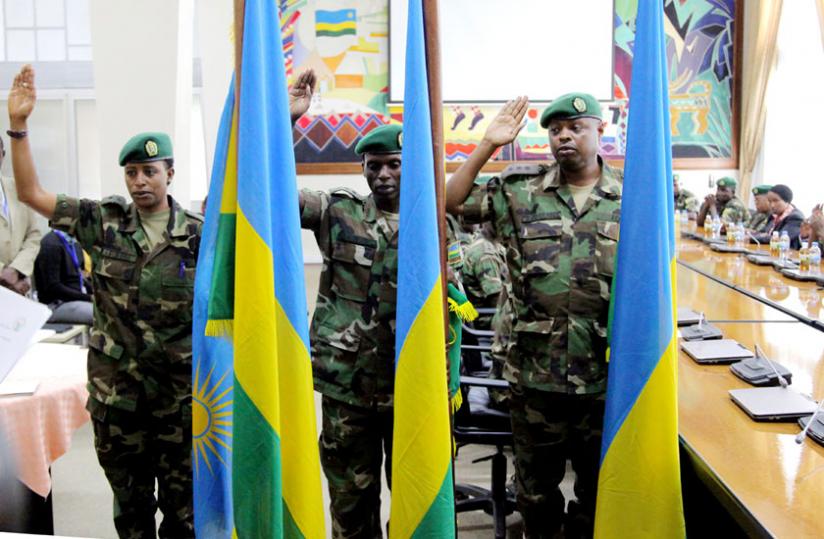L-R; Judges of the Military High Court Lt. Agasaro, Capt. Karakire and Capt. Rwaburindi take oath at the Prime Minister's office in Kigali yesterday. (John Mbanda)