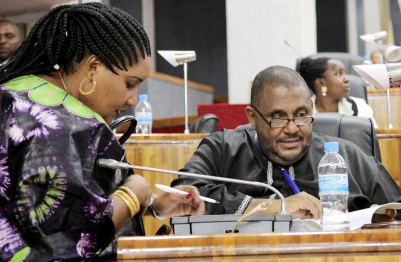 EALA members Angela Kizigha (L) and Abubakar Zein consult before the House was adjourned yesterday. (John Mbanda)