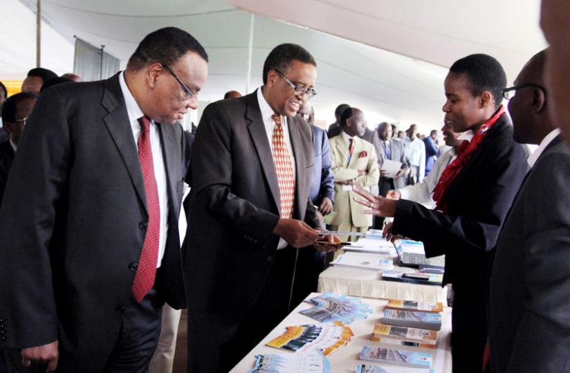 Kenyan High Commissioner to Rwanda John Mwangemi (L) with Education minister Silas Lwakabamba tour Muhimbili University (Tanzania) stand at the expo organised by the Academia-Public-Private Sector Forum in Kigali yesterday. (John Mbanda)