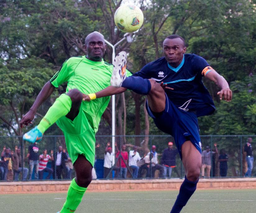 The hat trick hero Tuyisenge (R) jumps to control the ball from Kiyovu defender in midweek. ( T. Kisambira)