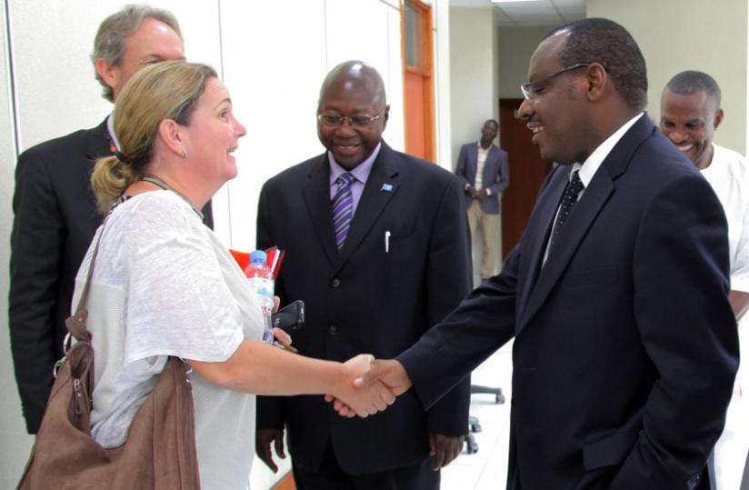 Finance minister Claver Gatete (right), greets Unicef Representative in Rwanda Noala Skinner, as UN resident coordinator Lamin Manneh, looks on at the signing ceremony yesterday. (John Mbanda)
