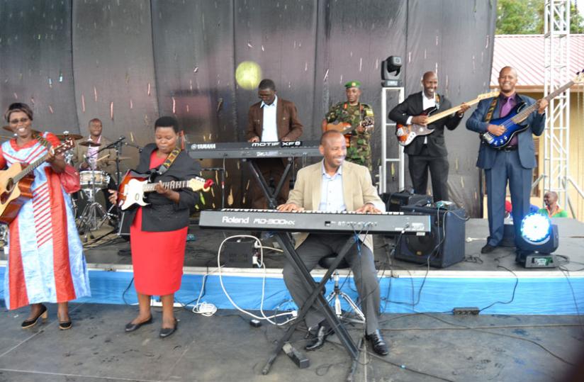 Officials play music instruments during the launch of the school. (Jean d'Amour Mbonyinshuti)