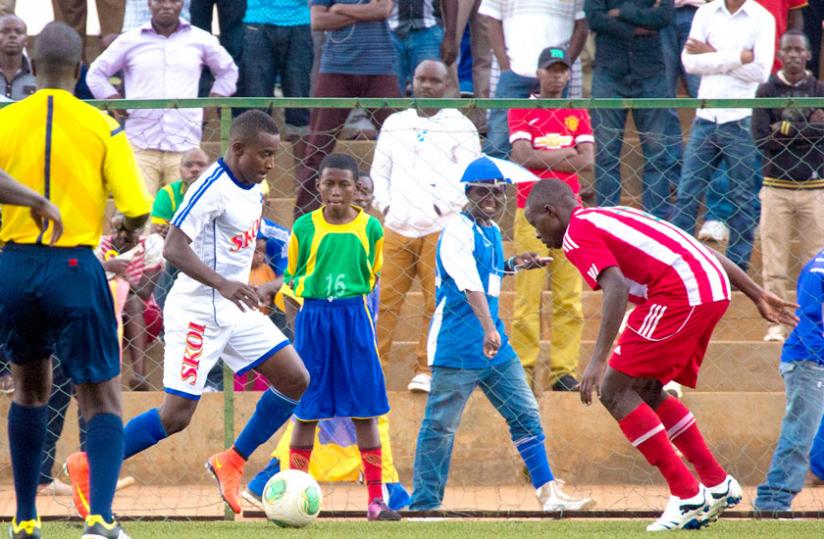 Rayon Sports captain Faudi Ndayisenga(L) with the ball, takes on Musanze defender. The captain scored the only goal for Rayon sports in a game that ended 1-1. (Timothy Kisambira)