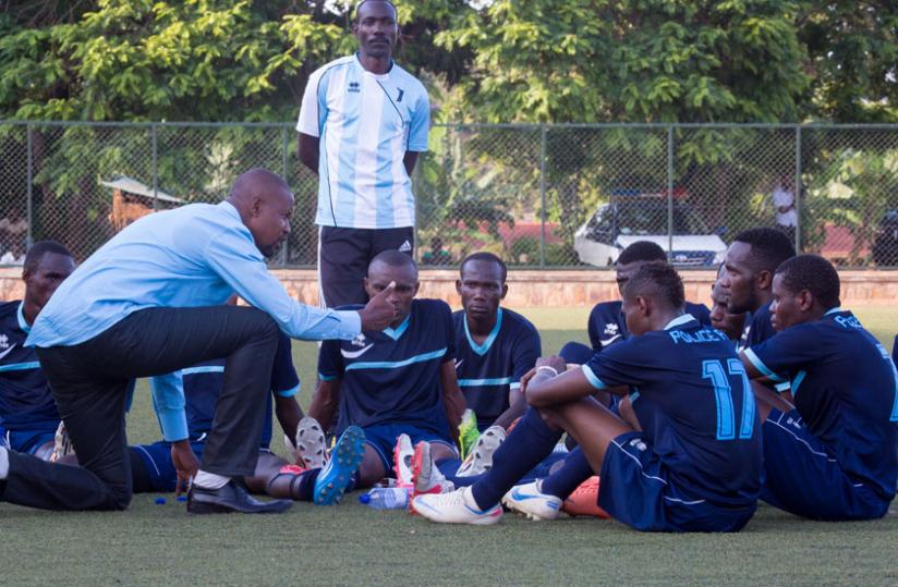 Police Coach Cassa Mbungo gives instructions to his players during half time. Both teams settled for a 0-0 draw. (Timothy Kisambira)