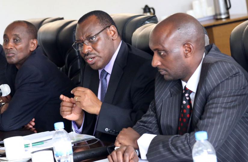 Minister Gatete makes a point during his appearance before PAC members at Parliament yesterday, while the Director General, Rwanda Public Procurement Authority, Augustus Seminega (L), and the Commissioner General, Rwanda Revenue Authority, Richard Tusabe (R), look on. (John Mbanda)