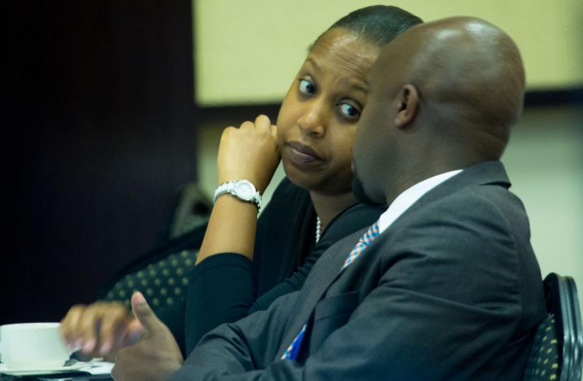 Kampeta chats with the Rwanda Stock Exchange CEO Pierre Cu00c3u00a9lestin Rwabukumba at the meeting in Kigali yesterday. (Timothy Kisambira)