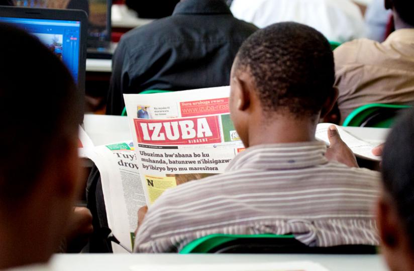 A journalism student at University of Rwandau00e2u20acu2122s School of Arts and Social Sciences reads  Izuba, a Kinyarwanda newspaper. The method of representing the sounds of the local dialect by written or printedu00c2u00a0symbols have been revised. (Timothy Kisambira)