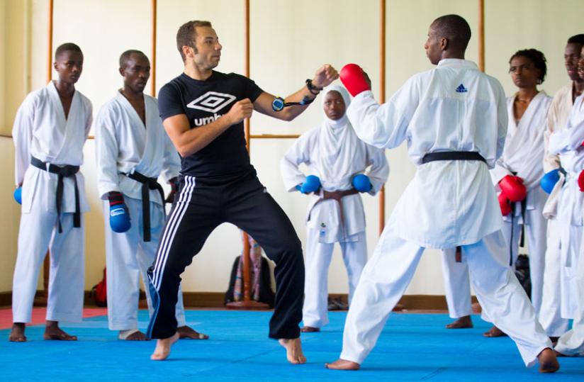 New Egyptian coach Tamer Abdel-Raouf tips Vanily Ngarambe on how to take on an opponent during training yesterday.(Timothy Kisambira)