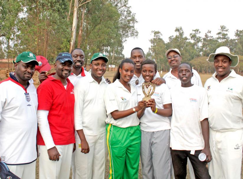 Abakambwe team show off one of the trophies they have won in recent years.