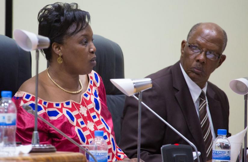 Nirere (L), together with Etienne Niyonzima, a commissioner, present the rights report before Parliament yesterday. (Timothy Kisambira)