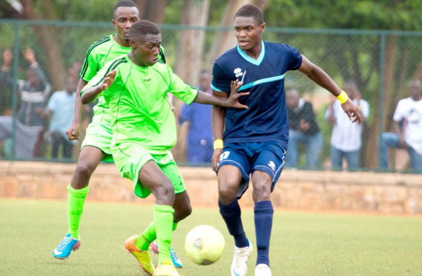 Police striker Emmanuel Sebanani (L) in action against Kiyovu. Coaches are worried the fixture pile up will affect the players. (Timothy Kisambira)