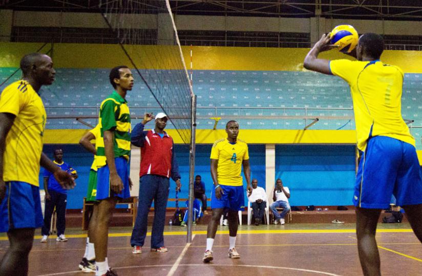 Head coah Paul Bitok (in red jacket) watches on during the teamu00e2u20acu2122s training session early this week at Amahoro indoor stadium. (Timothy Kisambira)